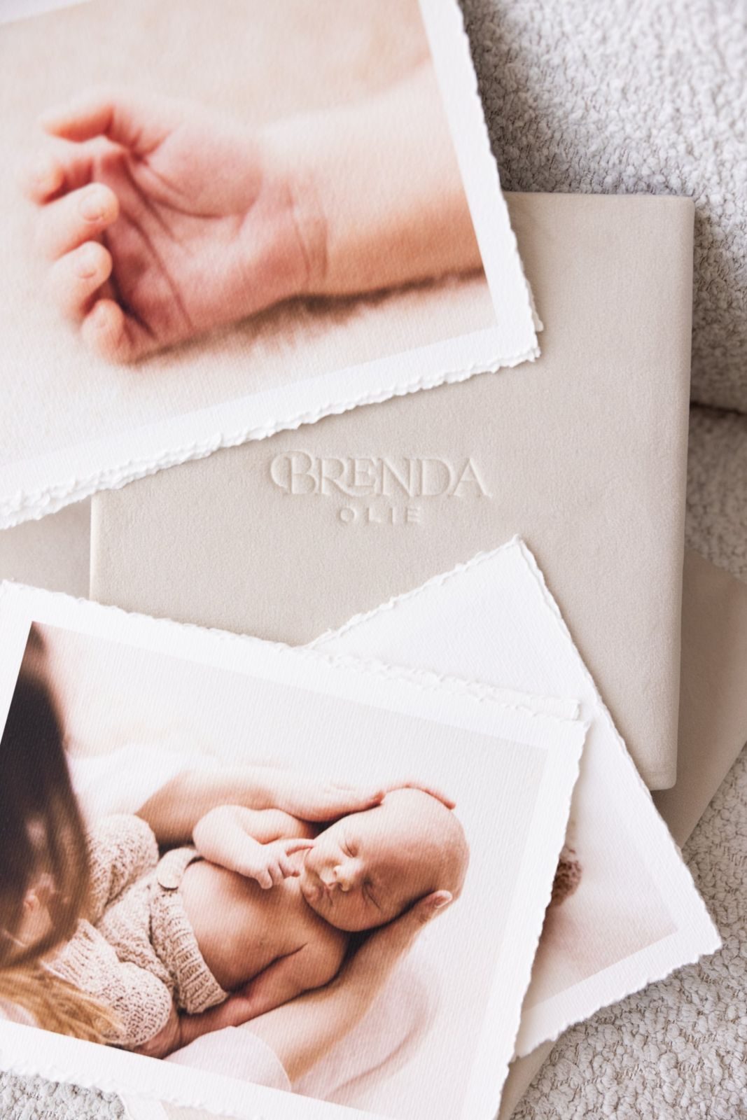 Prints and an embossed album laid out on a table